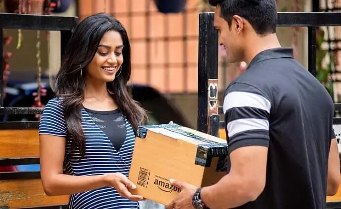 A girl taking her parcel from the delivery boy