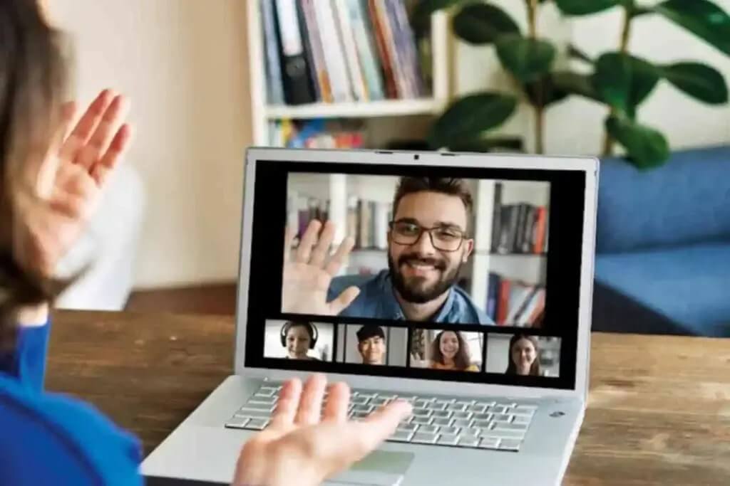 A person is teaching online tuition through video call on a laptop