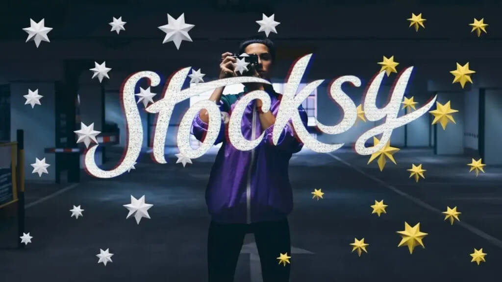 A person holding a camera stands behind the bold 'stocksy' text."